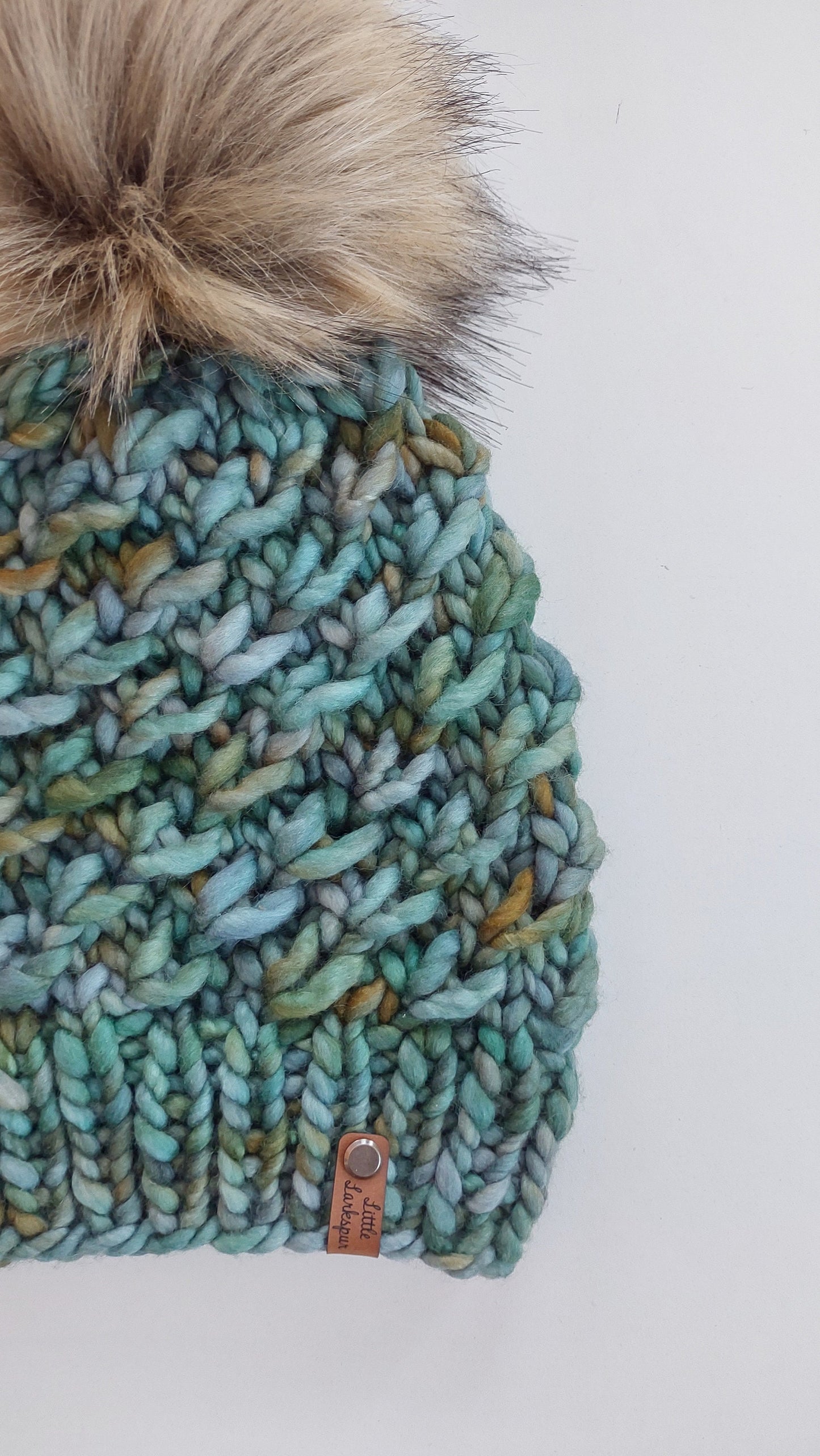 Luxury Adult Merino Wool Hand Knit Hat. Crush Hat. Soft hand knitted hat. Malabrigo Rasta. Greens & blues beanie with faux fur pom pom.